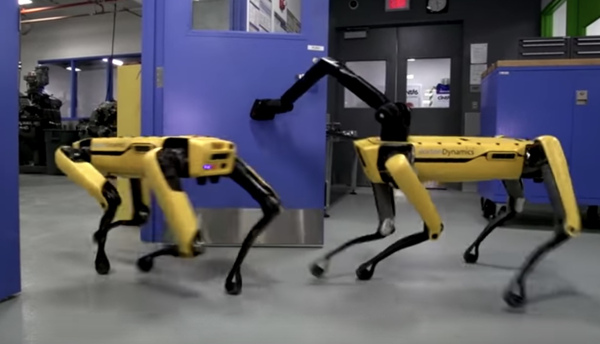 Two Boston Dynamics robots cooperate to open a door in an autonomous manner
